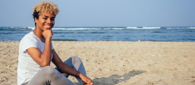 brazilian hispanic woman training yoga on the beach