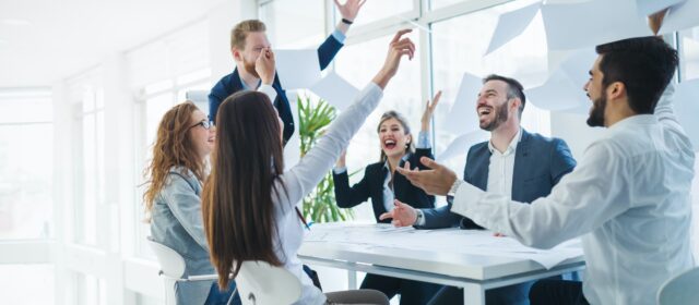 Successful business people celebrating achieved business goals